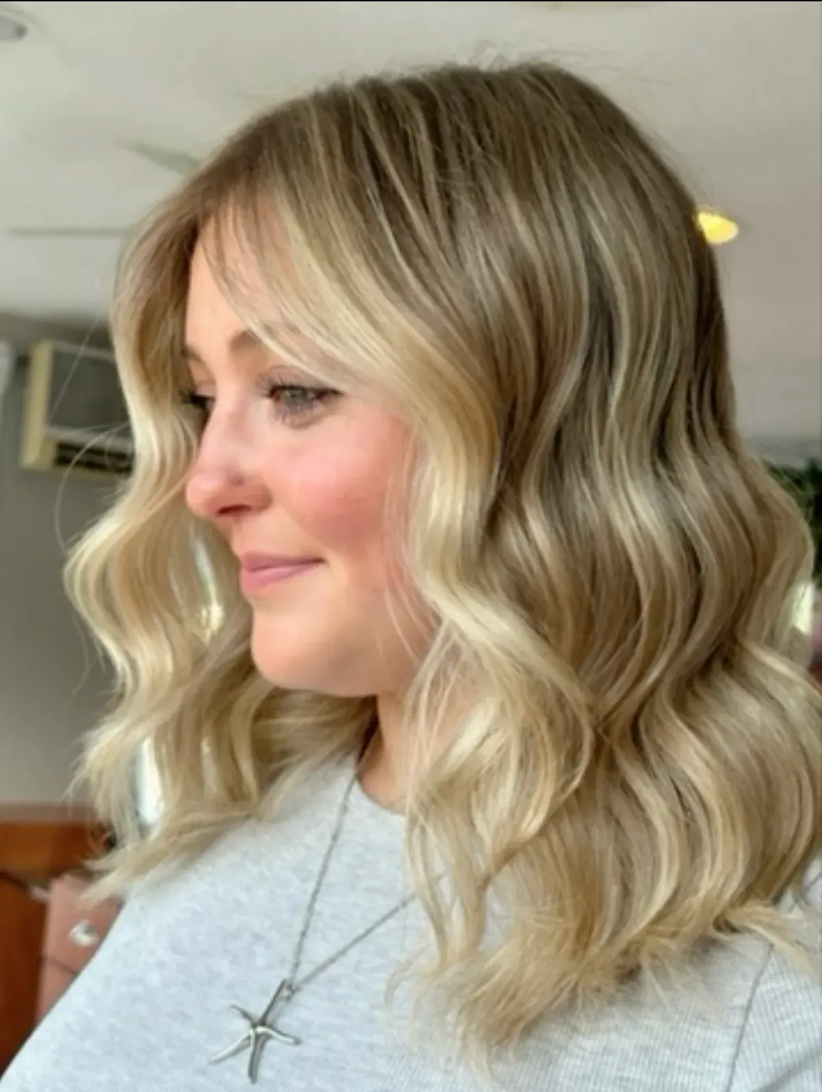 Dimensional balayage blonde with soft face-framing waves