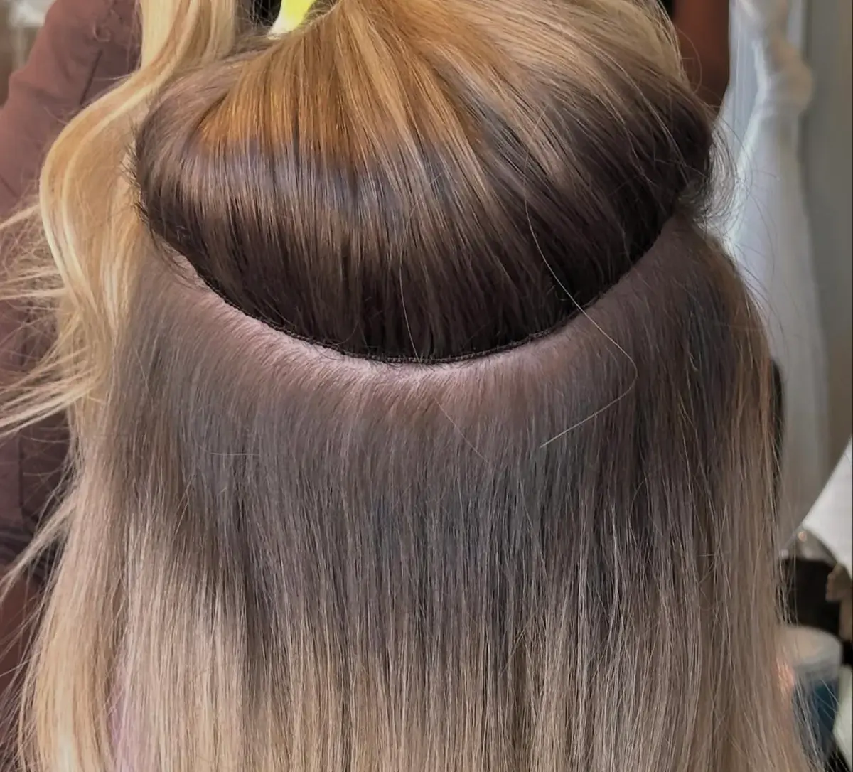 A hand-tied Invisible Bead Extensions row during an install