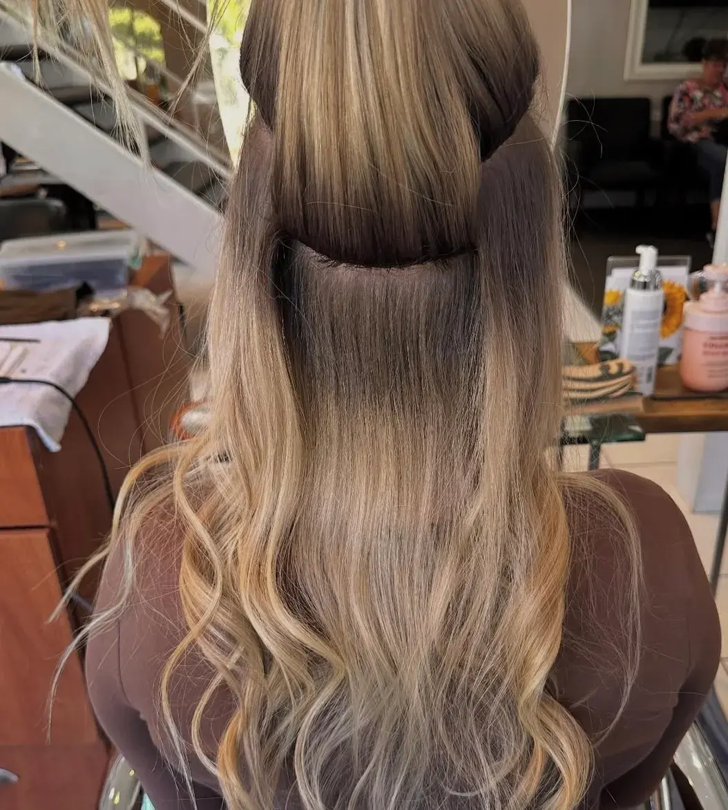 Hand-tied weft rows on a beaded foundation mid-install
